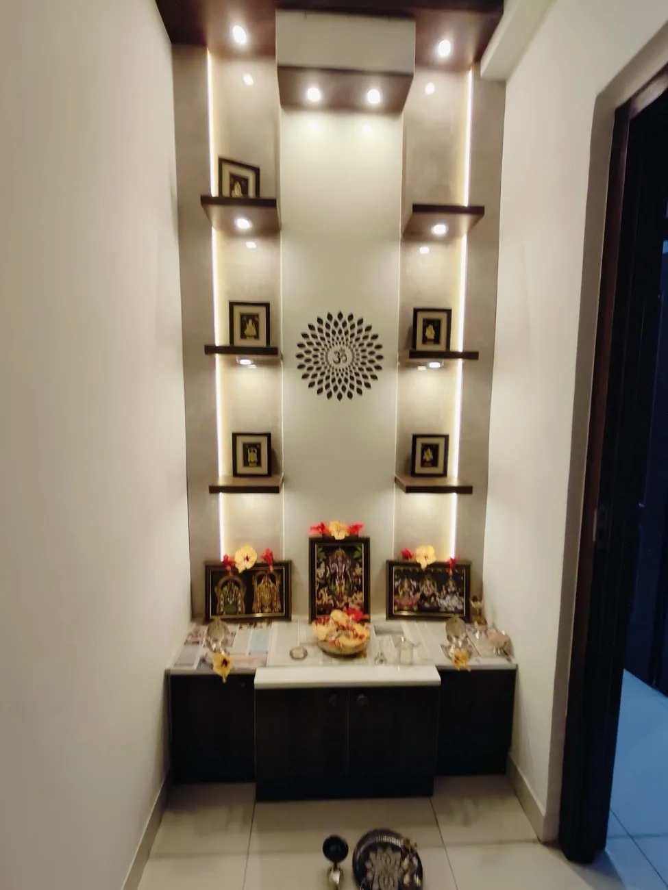 Pooja room with a custom mandir and backlit wall detailing